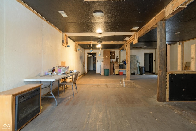 basement featuring heating unit and hardwood / wood-style floors