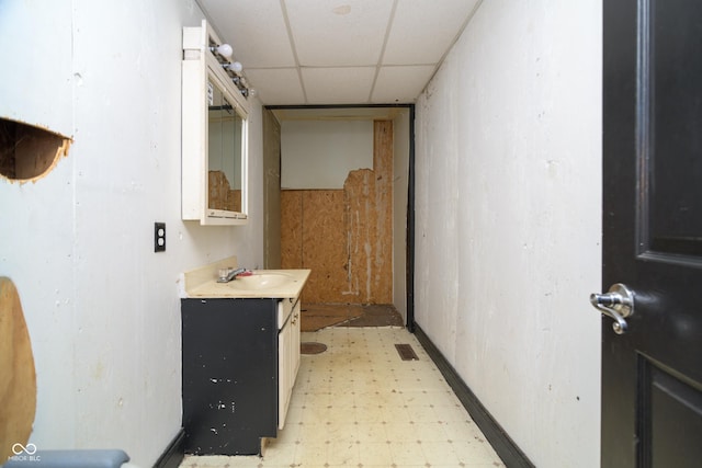 bathroom featuring a drop ceiling and vanity