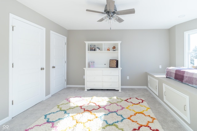 bedroom featuring ceiling fan and light colored carpet