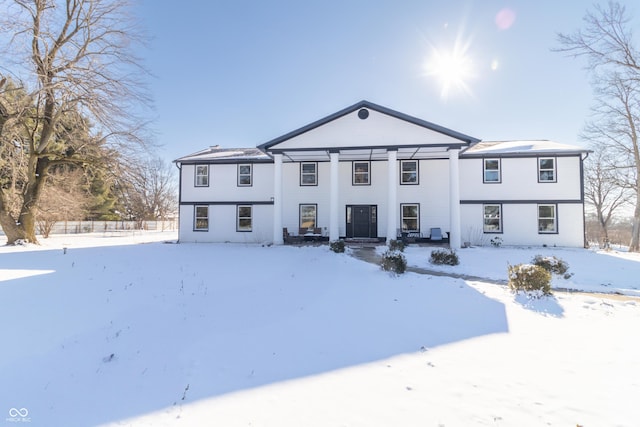 view of snow covered back of property