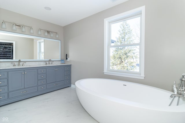 bathroom with a tub and vanity