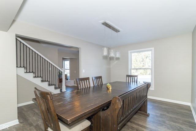 dining space featuring dark wood-type flooring