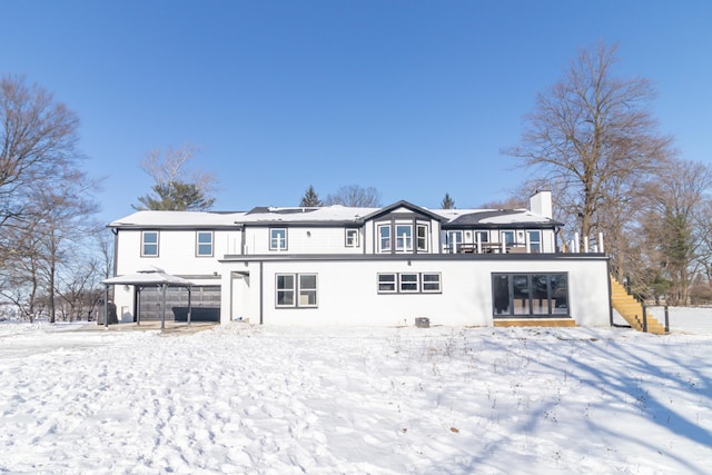 snow covered rear of property featuring a gazebo