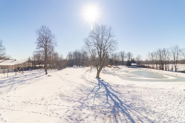 snowy yard featuring a rural view