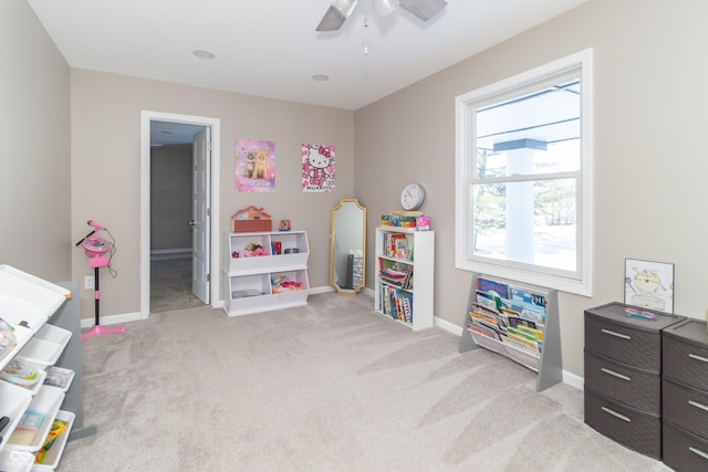 playroom featuring light colored carpet and ceiling fan