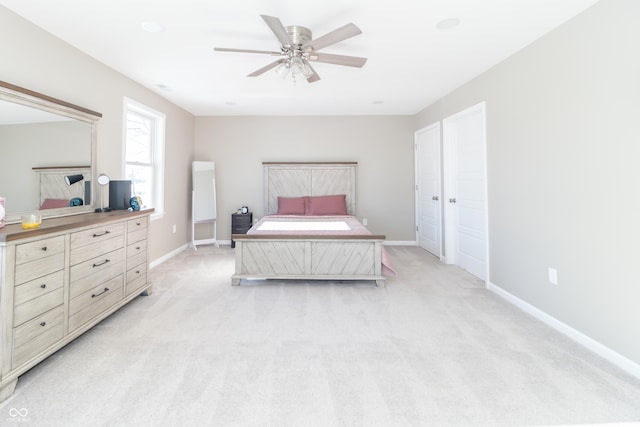 carpeted bedroom featuring a closet and ceiling fan