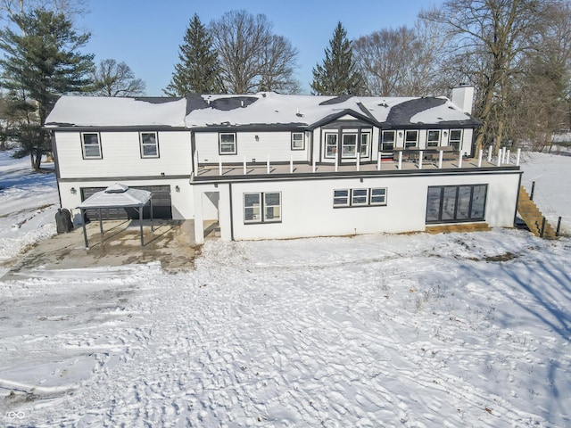 view of snow covered rear of property