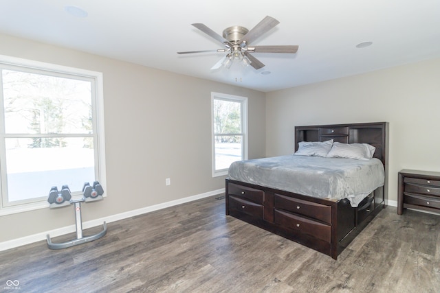 bedroom with ceiling fan and dark hardwood / wood-style flooring