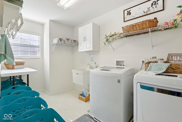 laundry area with sink, cabinets, and washing machine and clothes dryer