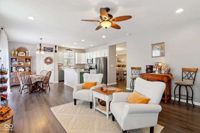 living room featuring dark hardwood / wood-style flooring and ceiling fan