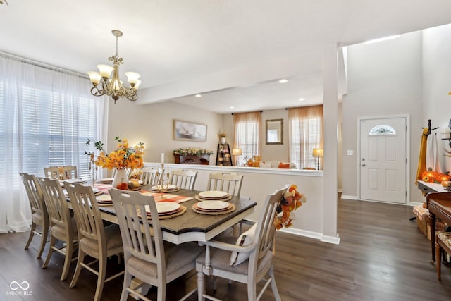 dining space with plenty of natural light, dark hardwood / wood-style flooring, and a notable chandelier