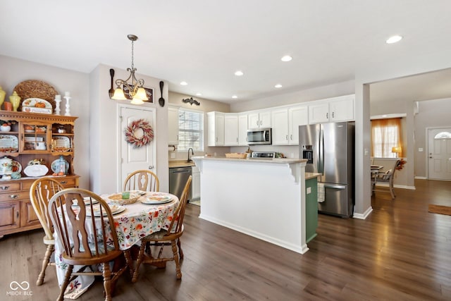 dining room with dark hardwood / wood-style floors and a chandelier