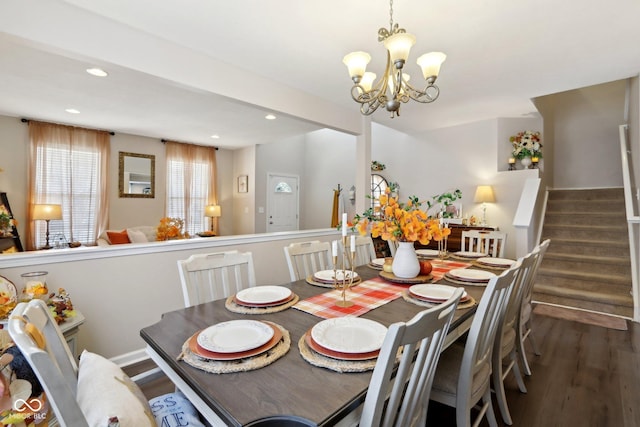 dining room with dark hardwood / wood-style floors and a chandelier