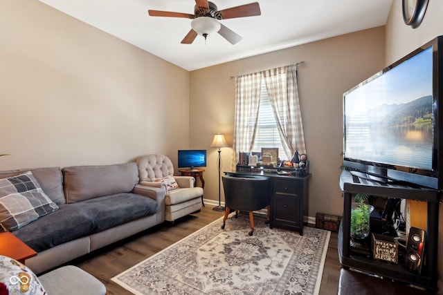 living room featuring ceiling fan and dark hardwood / wood-style flooring