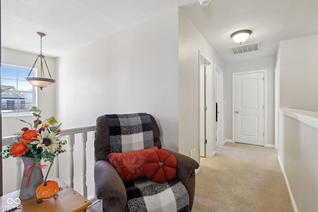 hallway with light colored carpet