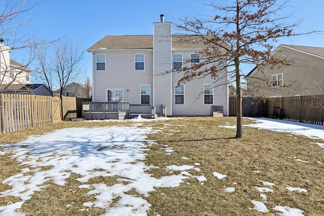 snow covered property featuring a wooden deck