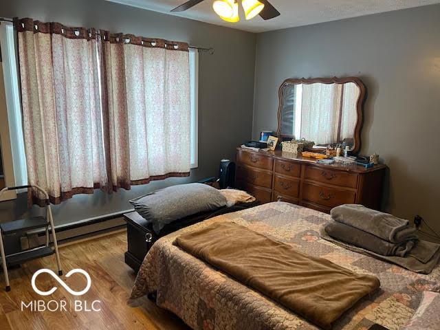 bedroom with ceiling fan and light hardwood / wood-style flooring