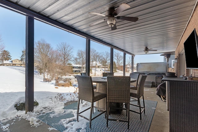 snow covered patio featuring ceiling fan