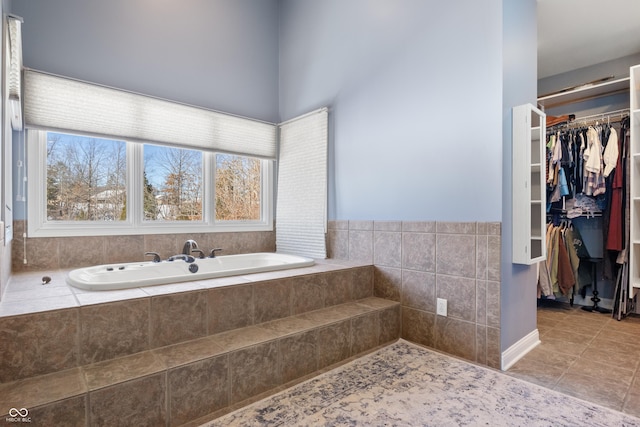 bathroom with a relaxing tiled tub