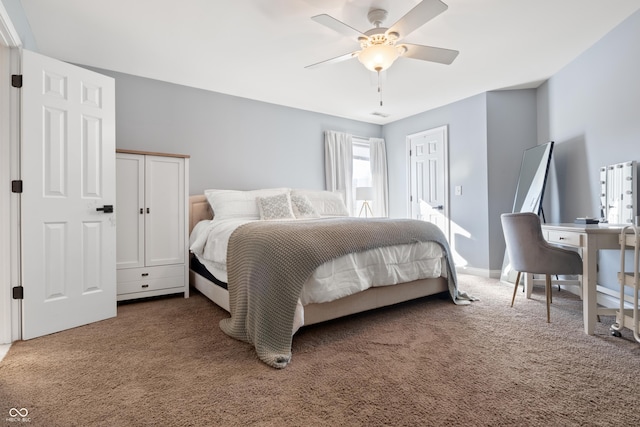 carpeted bedroom with ceiling fan and baseboards