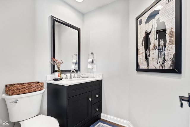 bathroom featuring toilet and vanity