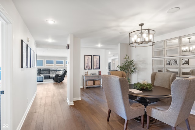 dining space featuring an inviting chandelier and wood-type flooring