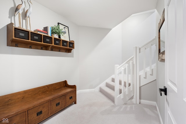 mudroom featuring carpet and baseboards