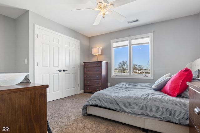 bedroom with ceiling fan, carpet floors, a closet, and visible vents