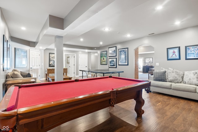 recreation room featuring arched walkways, wood finished floors, and recessed lighting