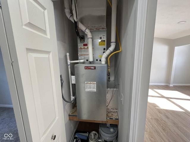 utility room featuring heating unit