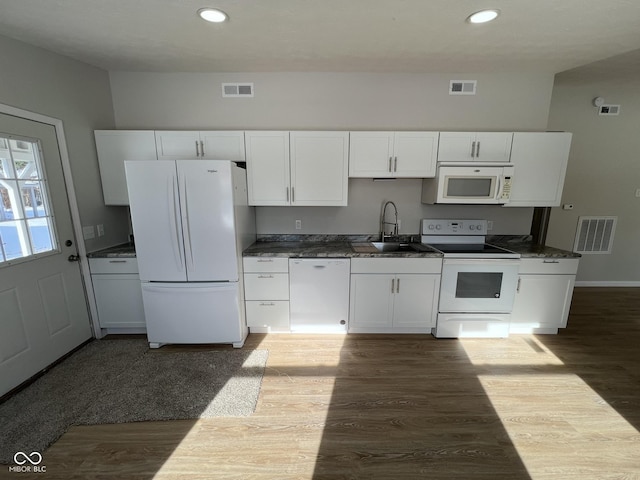 kitchen featuring white appliances, dark hardwood / wood-style floors, sink, and white cabinets