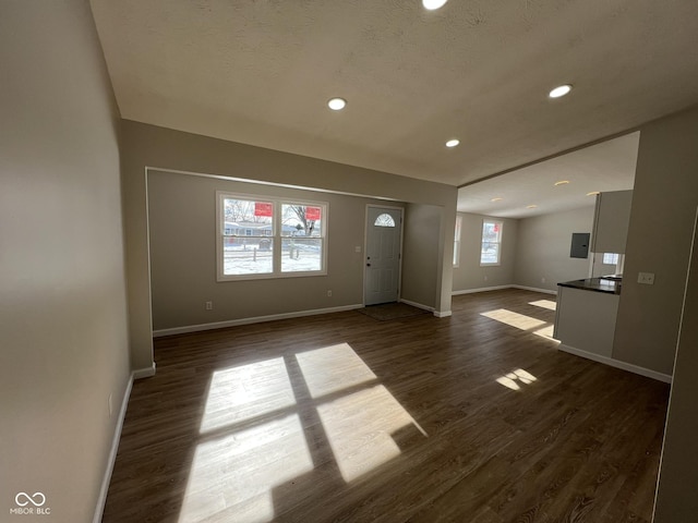 entryway with dark hardwood / wood-style floors and electric panel