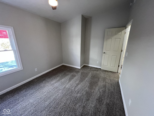 carpeted empty room with ceiling fan