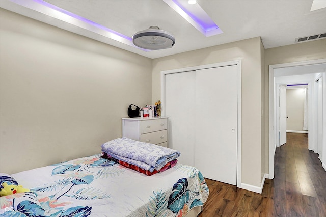 bedroom featuring dark wood-type flooring and a closet