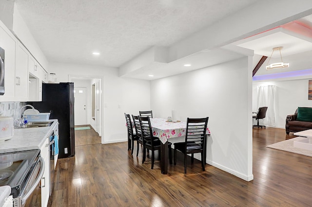 dining room with sink and dark hardwood / wood-style floors