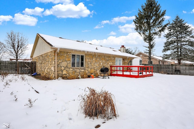 view of snow covered back of property