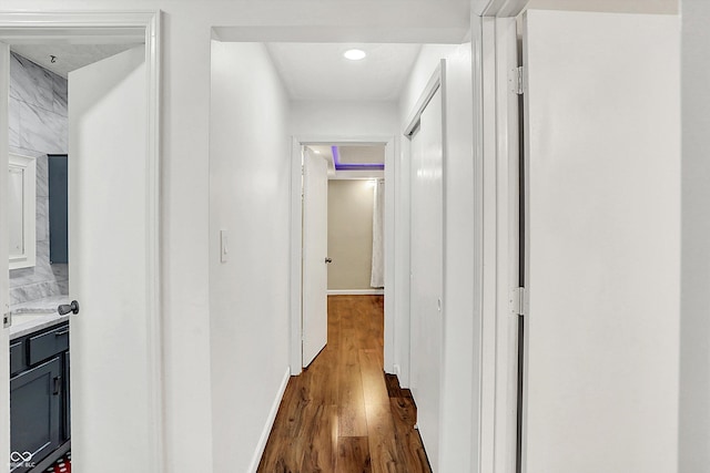 corridor featuring dark hardwood / wood-style flooring