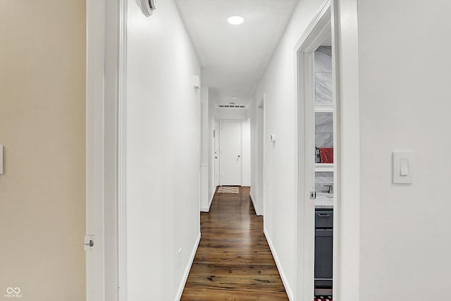 corridor with dark hardwood / wood-style flooring