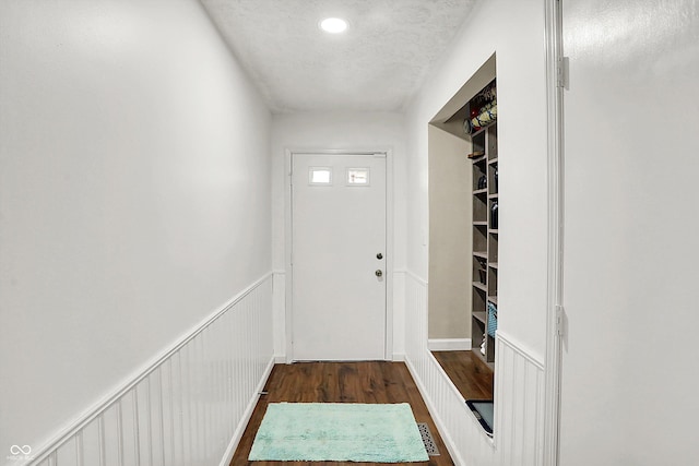 entryway with dark hardwood / wood-style floors and a textured ceiling