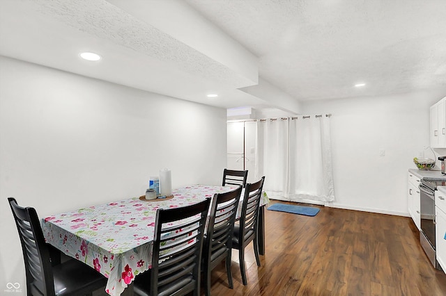 dining area with a textured ceiling and dark hardwood / wood-style floors