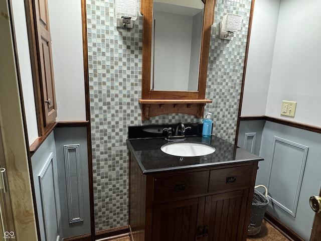 bathroom with vanity and tasteful backsplash