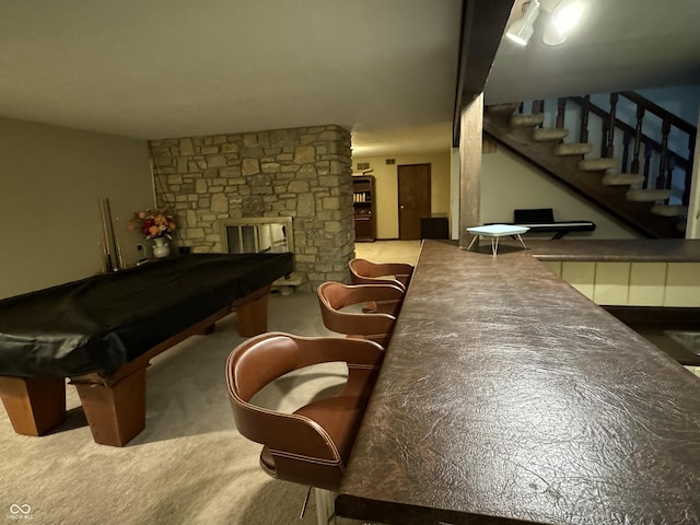 game room with carpet flooring, pool table, and a stone fireplace