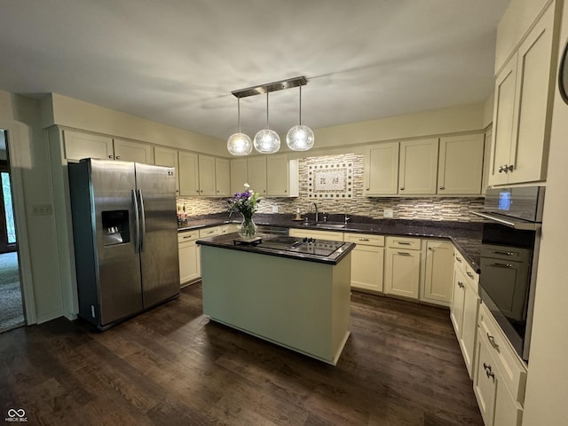 kitchen featuring stainless steel appliances, a center island, dark hardwood / wood-style flooring, pendant lighting, and sink