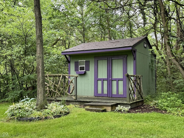 view of outbuilding with a yard