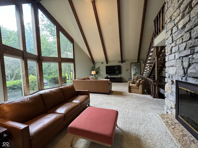 living room with a wealth of natural light, high vaulted ceiling, carpet floors, beam ceiling, and a fireplace