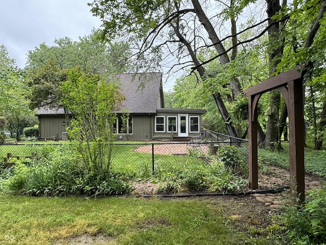 rear view of house featuring a lawn