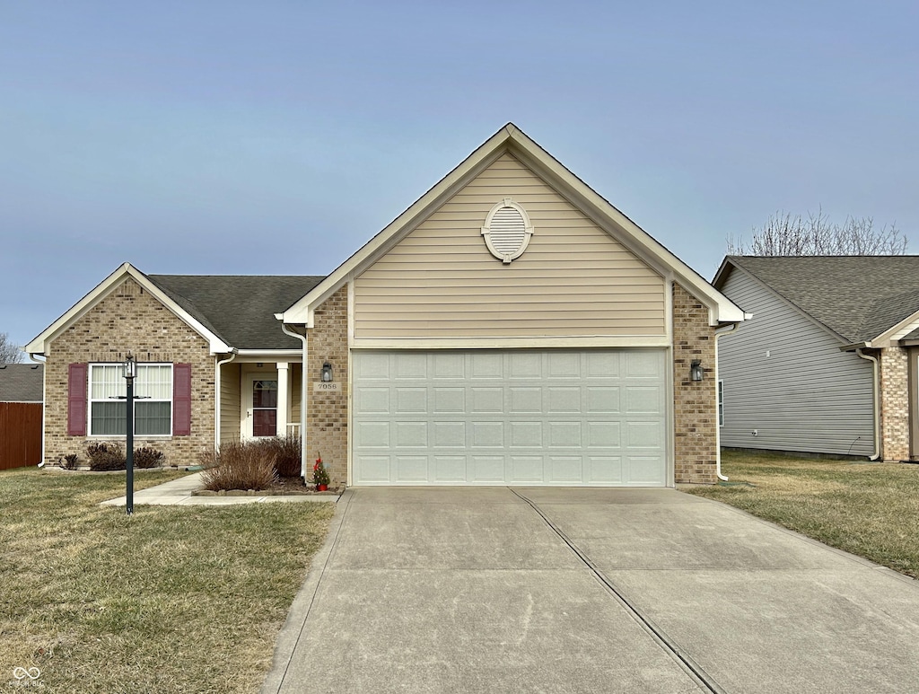 ranch-style house featuring a garage and a front lawn