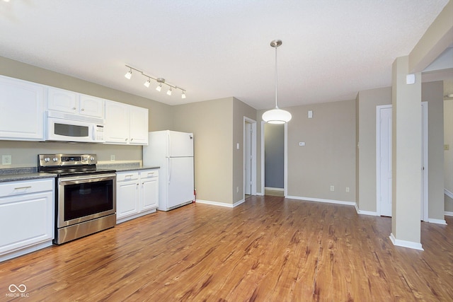 kitchen with hanging light fixtures, white cabinets, white appliances, and light hardwood / wood-style flooring