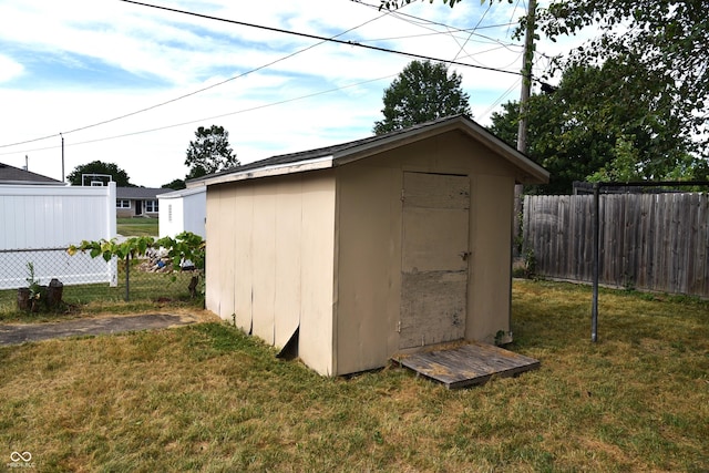 view of outbuilding featuring a lawn