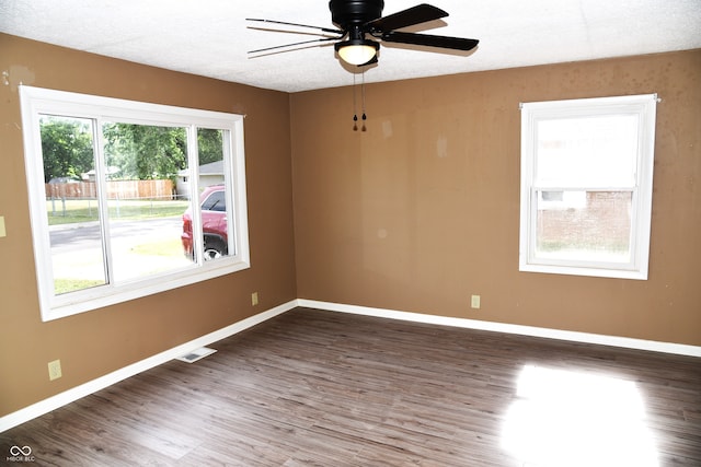 spare room featuring ceiling fan, a textured ceiling, and dark hardwood / wood-style flooring